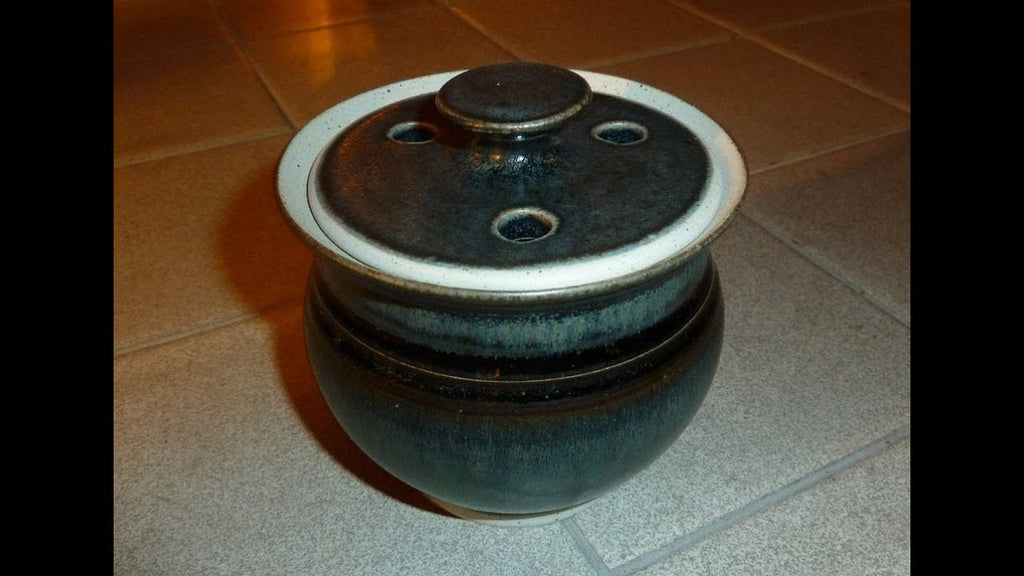 Making simple pot and lid on the wheel with holes punched out to store Garlic Bulbs in