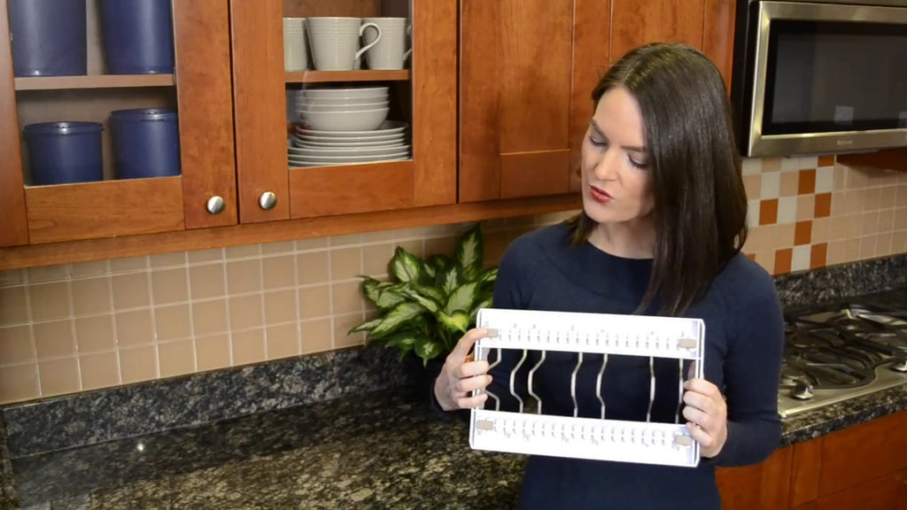 The StoreMore™ Lid Holder organizes all of your pot and pan lids in the cabinet or pantry